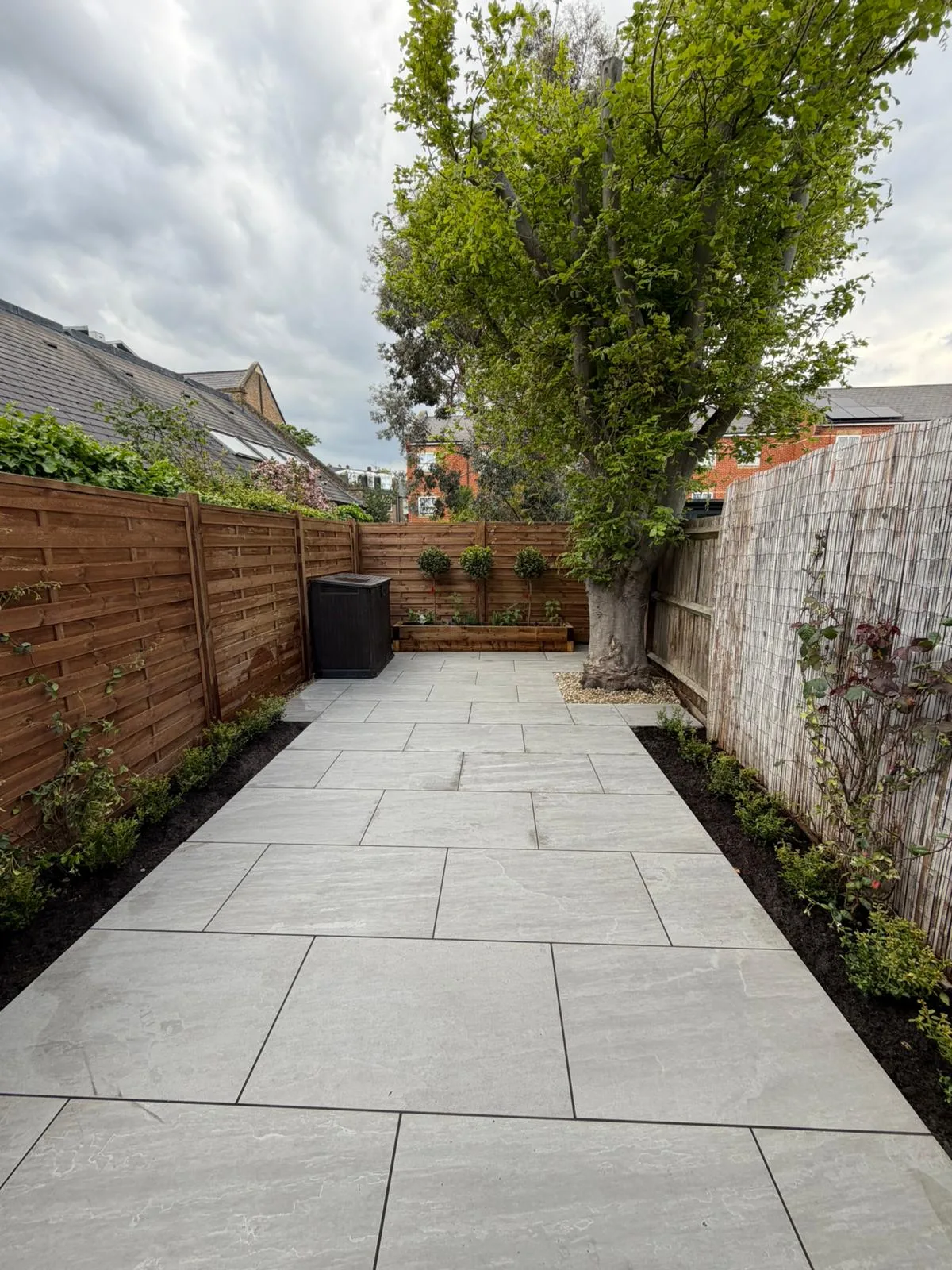 Full view of completed Battersea garden showing patio fencing and planting