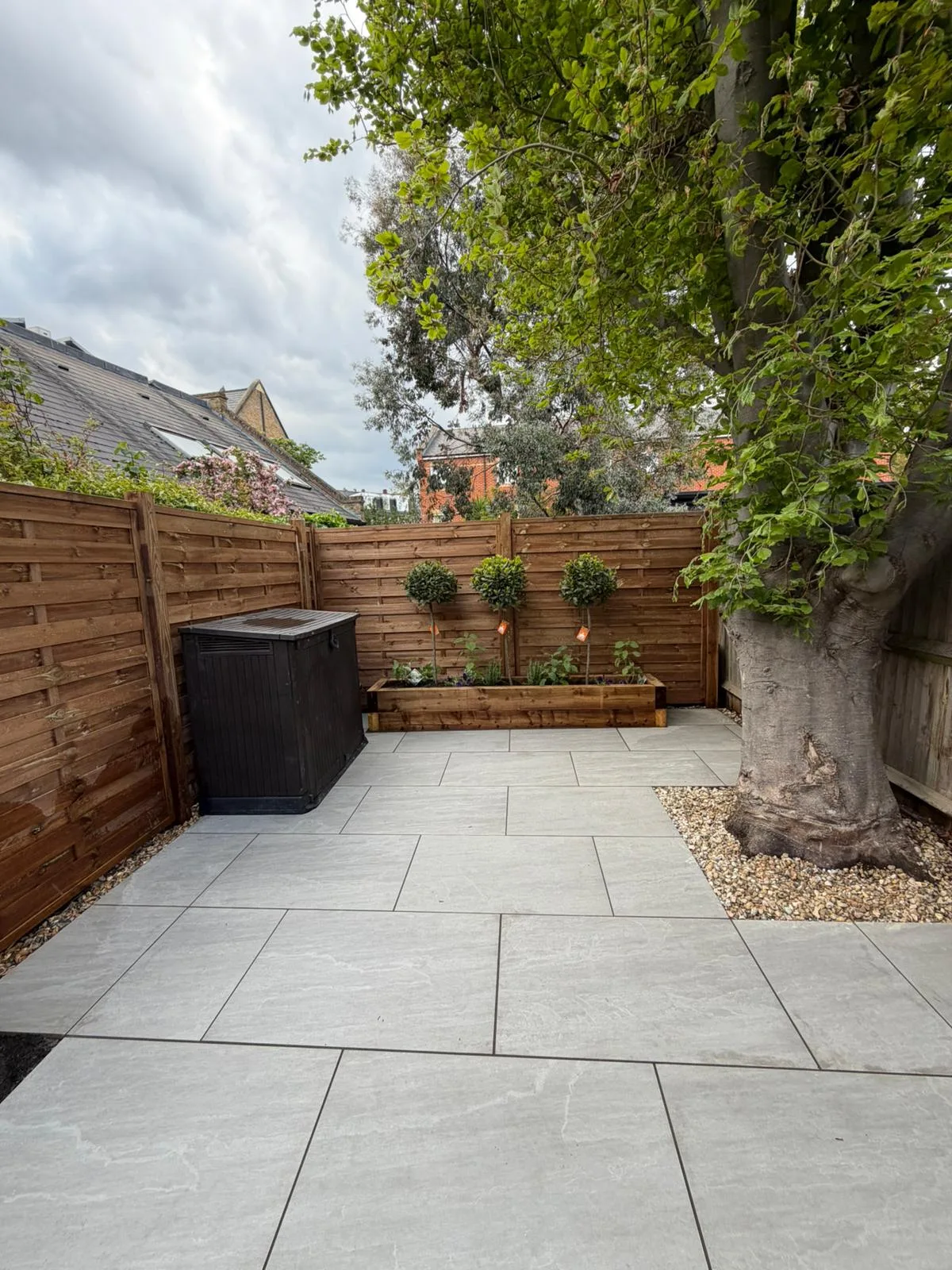 Completed Battersea garden showing sleeper bed patio and new fencing