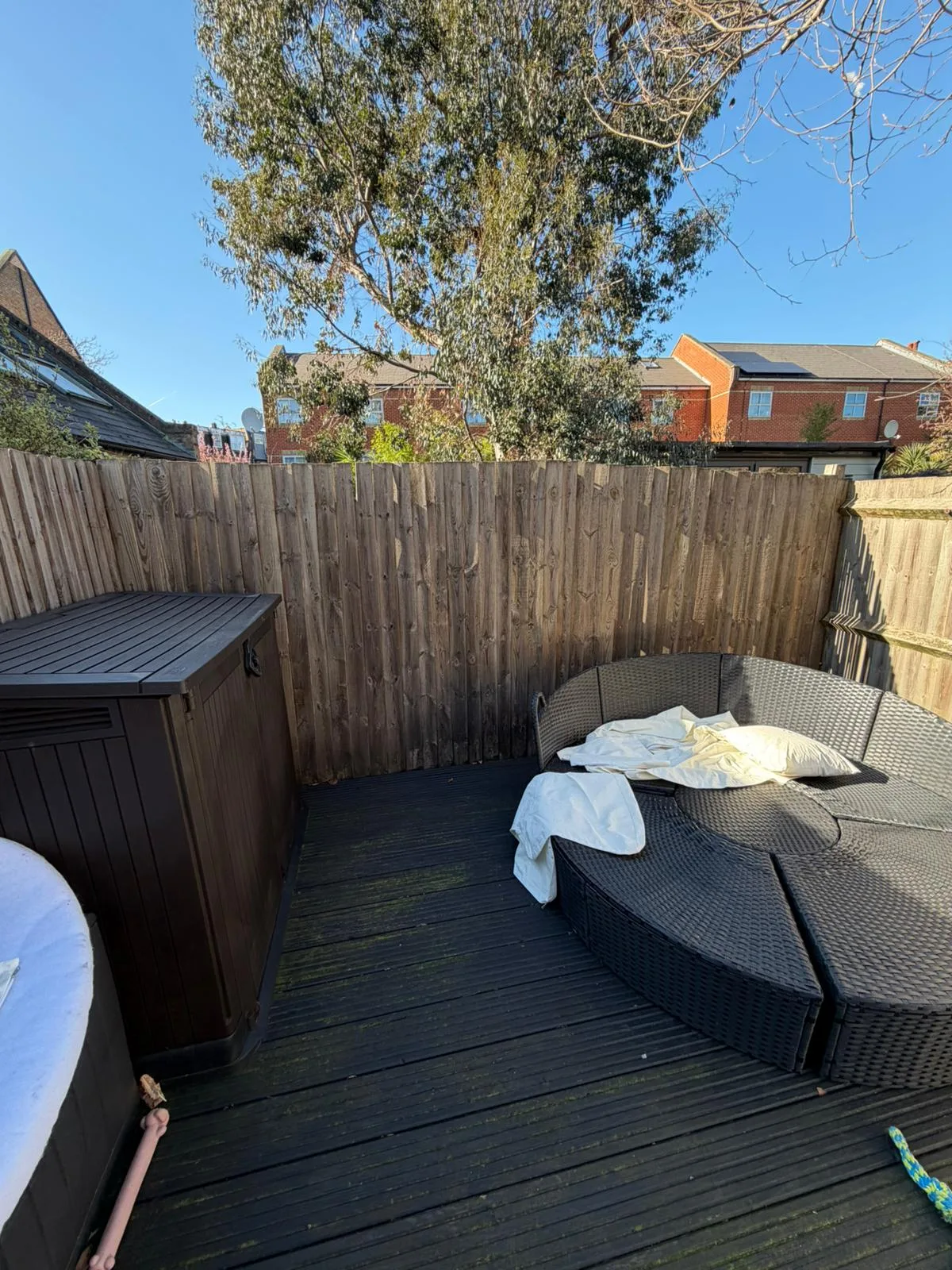 Old decking with garden furniture before removal in Battersea SW11