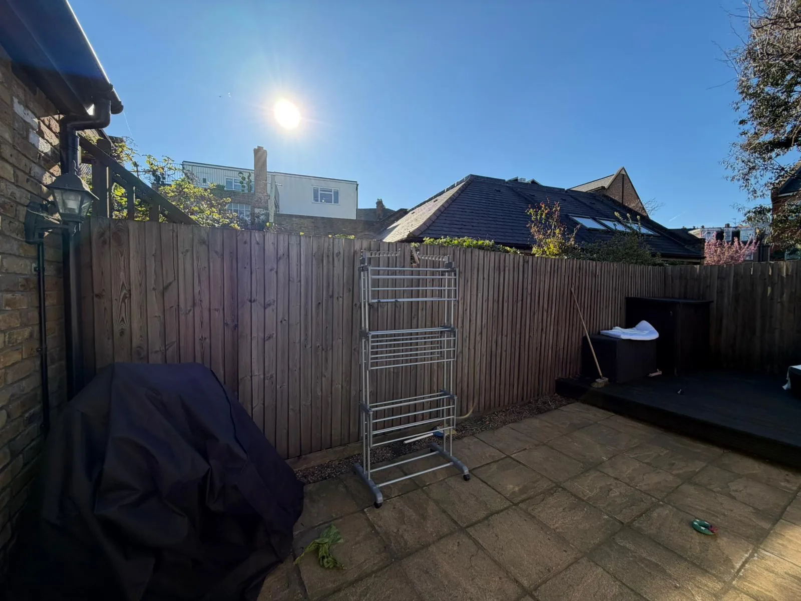 Old fence panels and paving slabs before replacement in Battersea