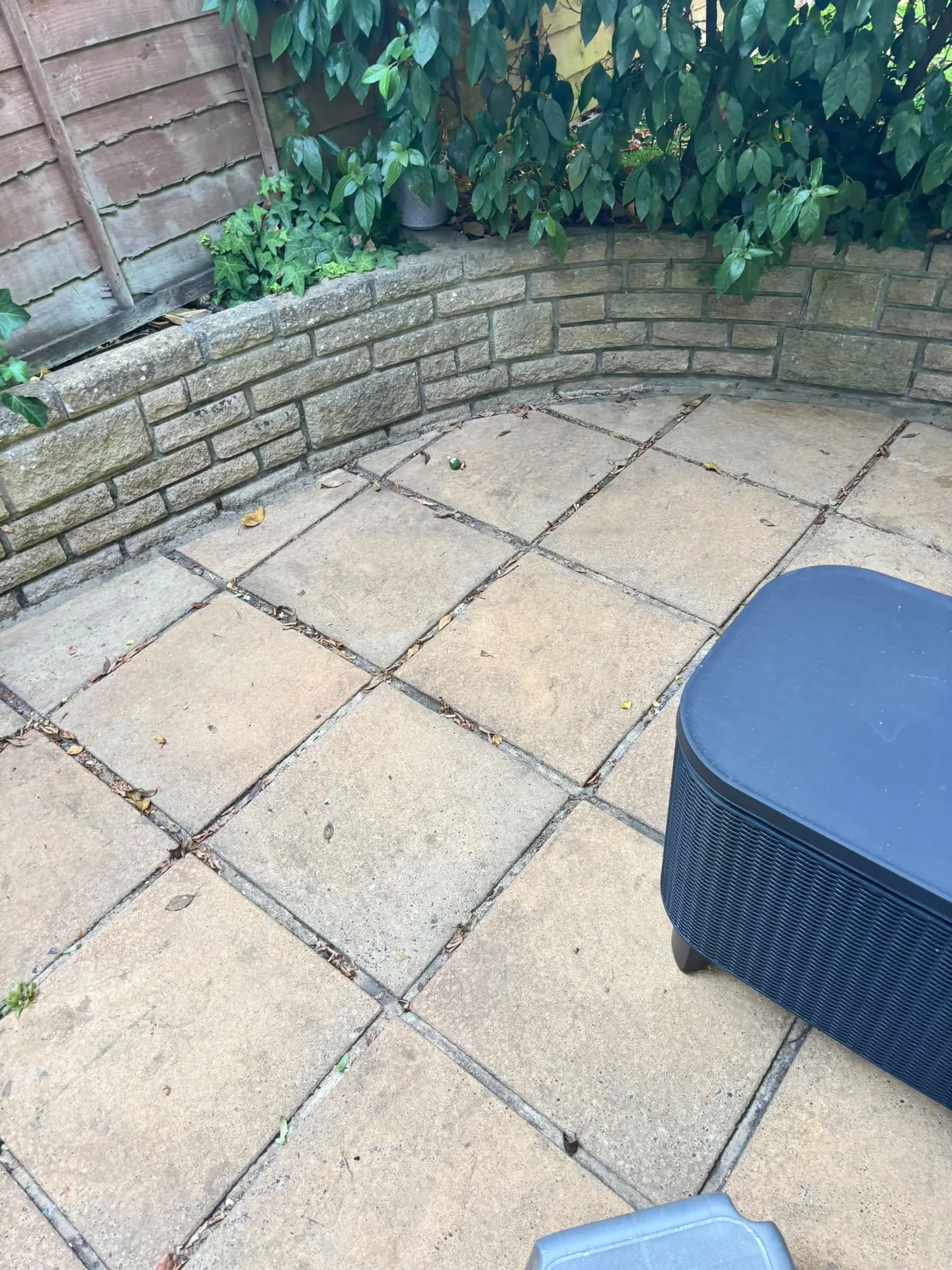 Bright, clean patio slabs and garden wall after pressure washing in Woodford, IG8 9JN