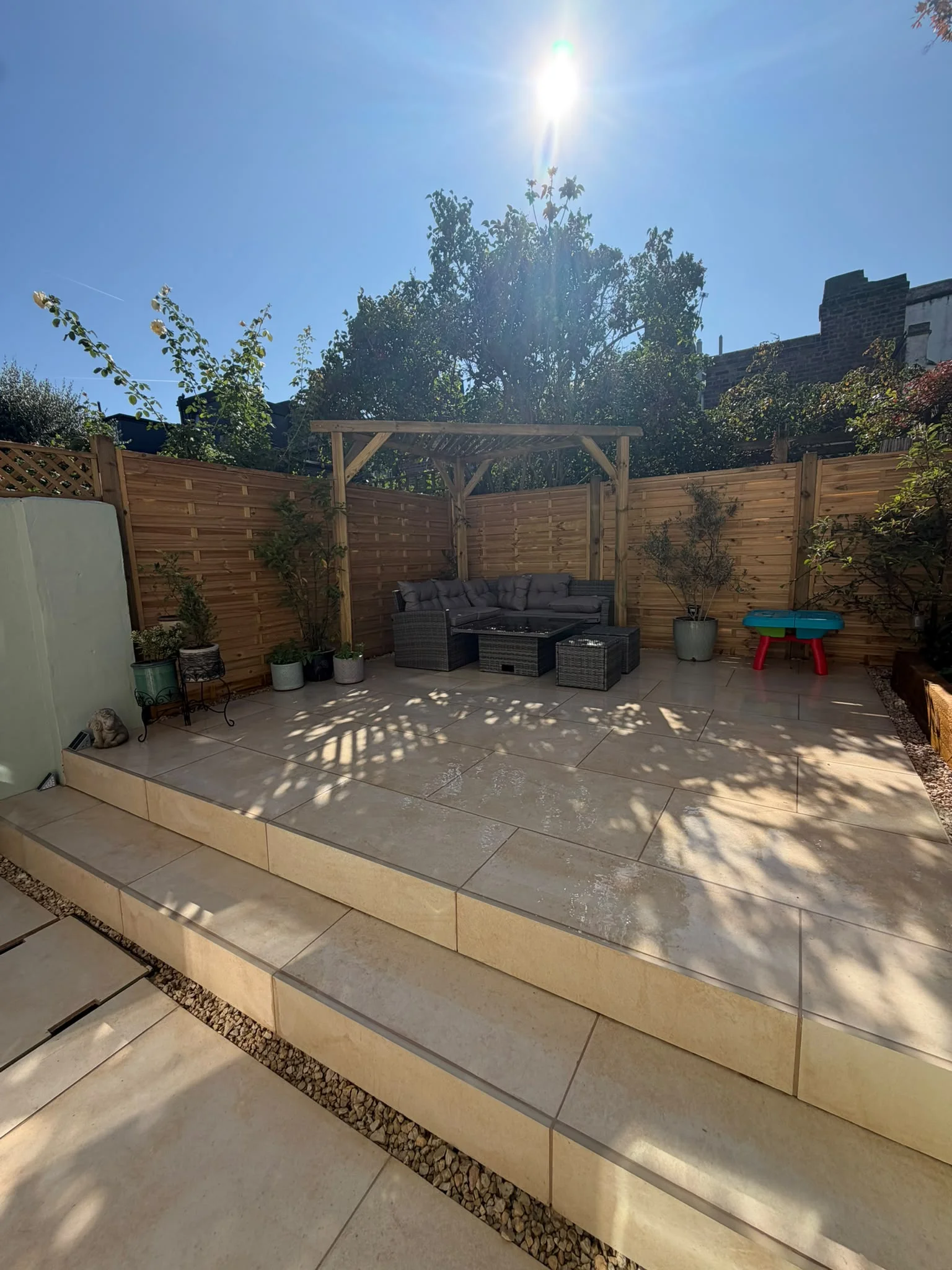 Pergola and Fencing Greenwich Newly landscaped Greenwich garden with timber pergola, new fence panels and porcelain patio seating area