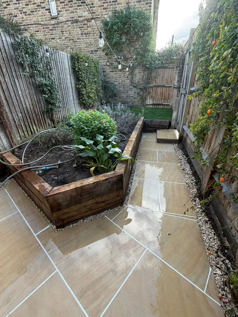 Sandstone paving pathway with raised timber planter beds